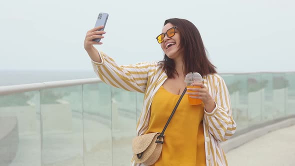 Beautiful happy young plus size woman 30-35 years old on vacation makes a selfie