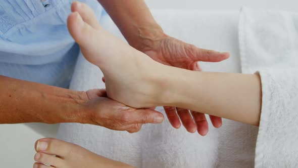 Close up of woman therapist massaging the feet of her patient alt