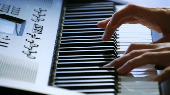 Female Hands Playing Piano. A Woman Touches the Keys with Her Fingers