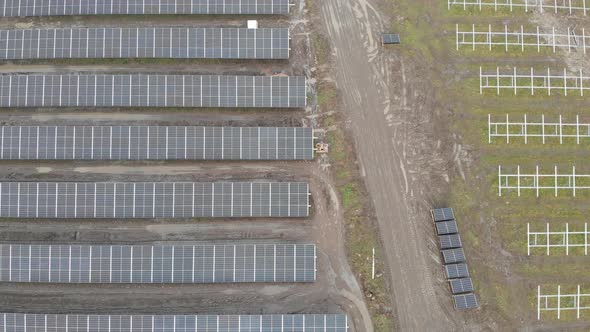 Aerial of Solar Panel Park Under Construction Dirt Road Low Top Down