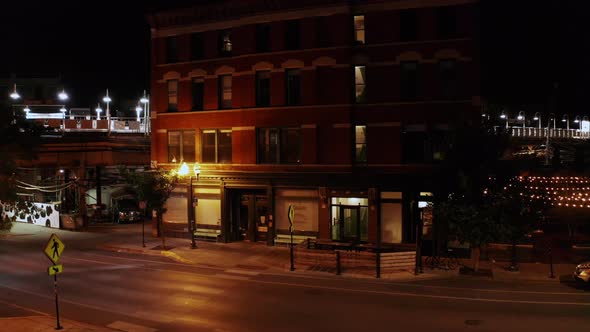 Aerial footage of an old Chicago motel by a rail train station late in the night. alt
