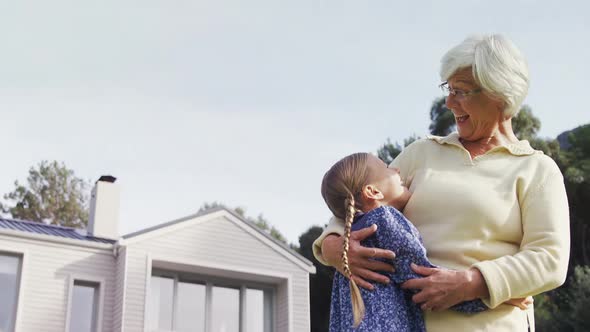 Grandmother and little girl hugging each other happily 4K 4k alt