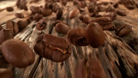 Super Slow Motion Detail Shot of Coffee Beans Strewing Towards at 1000Fps with Camera Motion alt