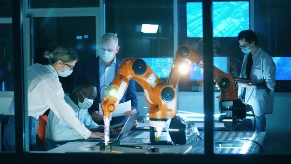 Robotics Engineers are Wearing Face Masks in the IT Laboratory alt