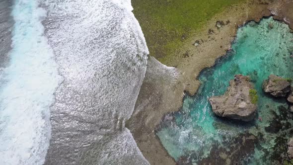 Aerial dolly over Magpupungko Rock Pools at high tide at Siargao, the Philippines alt