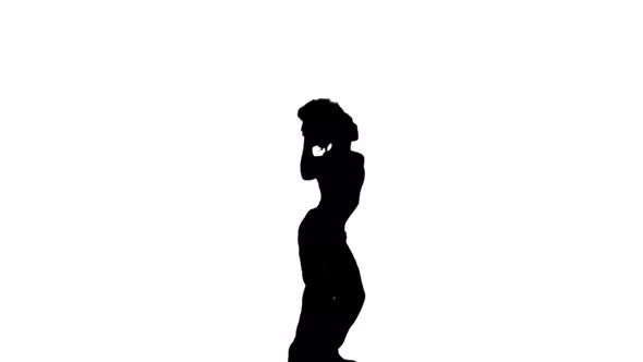 A Silhouette Man Is Casually Dancing Against A White Background
