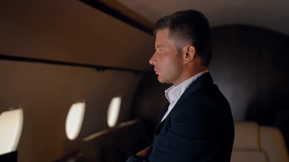 Confident Businessman Portrait in Private Jet. alt