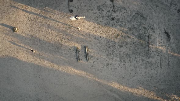 Top Down People Training Horse at Racecourse Aerial alt