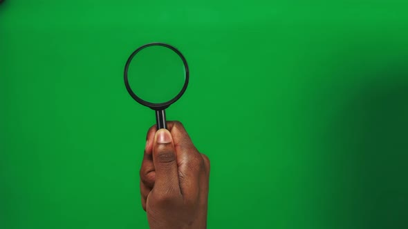 Set 3 Black Man Hands are Holding Magnifier Glass and Moving It on a Green Screen Background alt