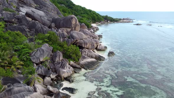 a beach with big rocks in the Seychelles