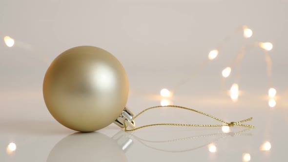 Decorative bauble in matte golden color slow tilt 4K 2160p 30fps UltraHD footage - Christmas tree or alt