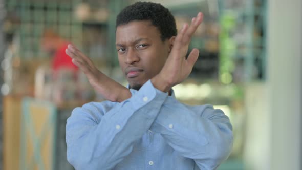 Young African Man Saying No with Hand Gesture alt