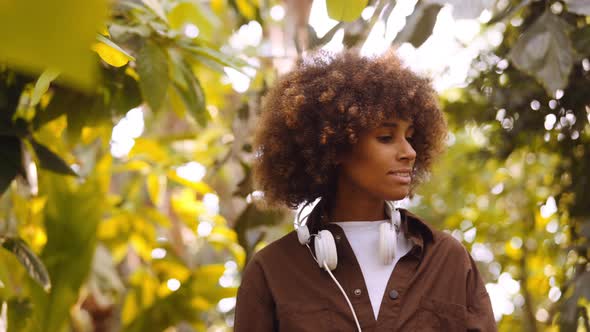 Young Woman Exploring Sunny Botanical Gardens alt