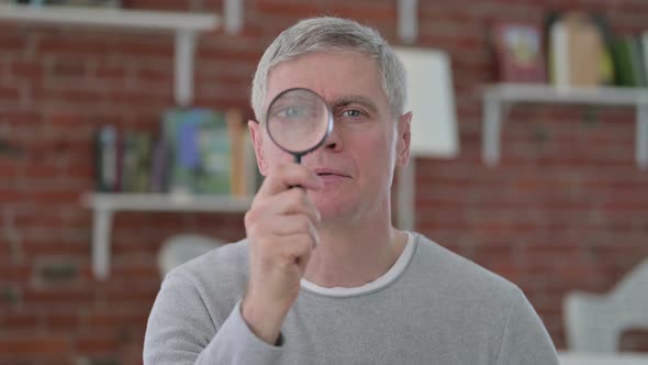 Senior Old Man Searching By Magnifying Glass alt