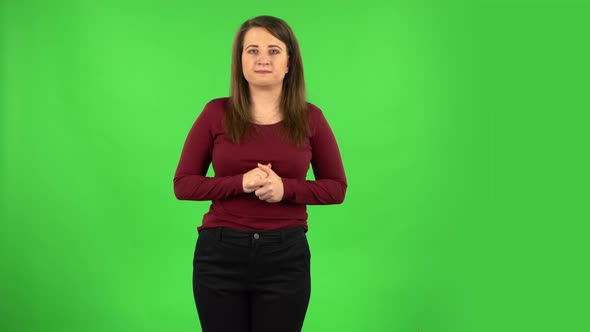 Pretty Girl Looking at Camera with Anticipation, Then Very Upset. Green Screen alt