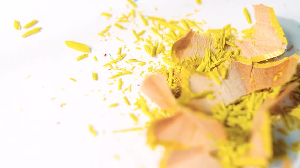 Yellow color pencils shavings on a white background alt