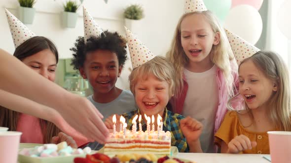 Kids Blowing out Candles on Cake alt