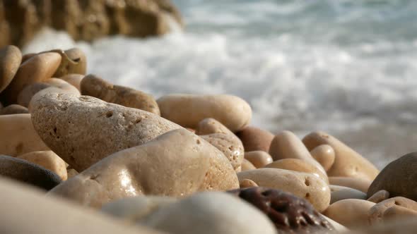Pebbles On Beach Close Up And Waves Crashing Shore