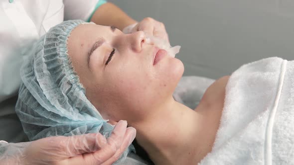 The Cosmetologist Removes the Cleansing Gel with a Cloth Napkin