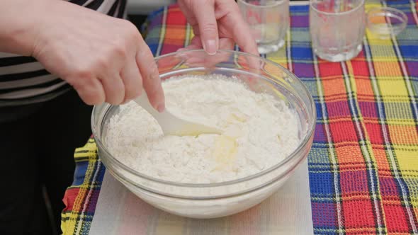 Senior Caucasian Woman Stirring Sweet Liquid Dough in the Bowl with White Plastic Spatula