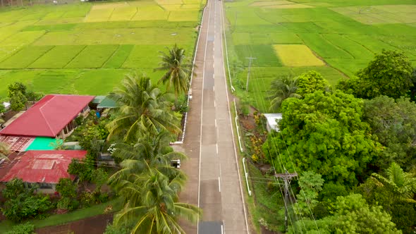 aerial drone over rice fields and small village in the Philippines 4k alt