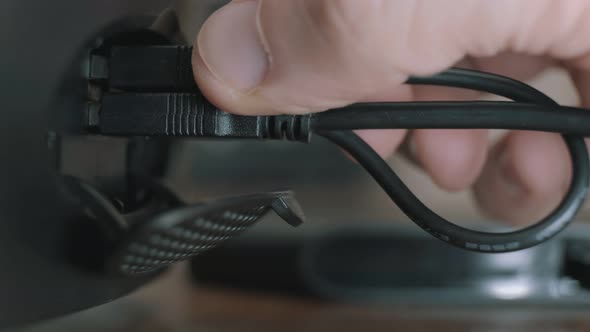 Man Connecting a Portable Device to a Computer Via a Usb Port alt
