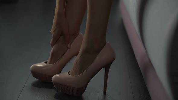 Woman Experiences Discomfort from Walking All Day in High Heels, Sore Muscles alt