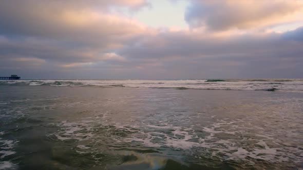 Slowly flying over rolling waves alt