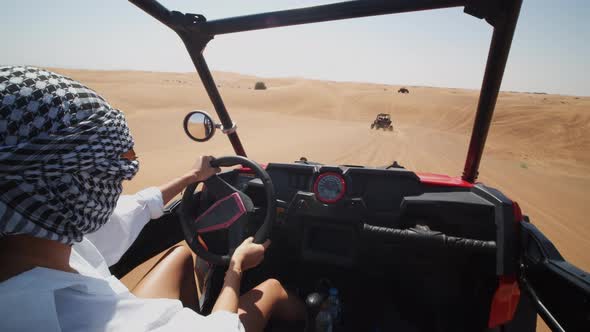 Woman Driving a Sand Dune Buggy in the Desert alt