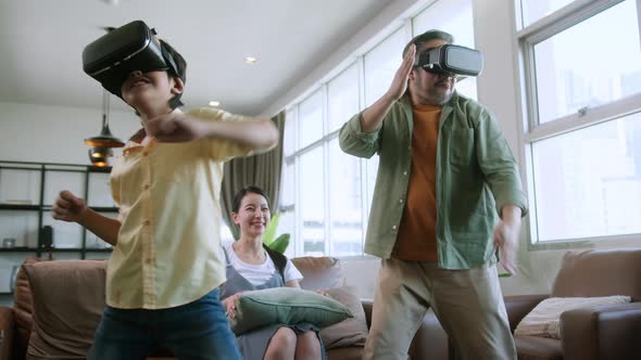 Dad and son wear VR or virtual reality glasses,headsets standing and playing a video