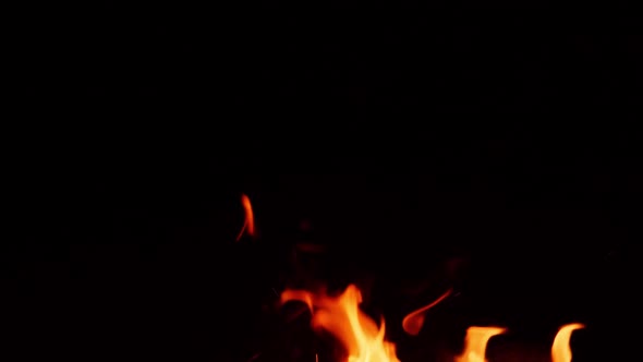 Flames from campfire burning at night