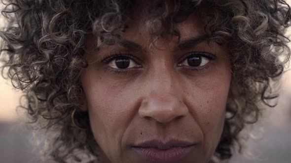 Outdoor Portrait of a Latina Woman Looking at the Camera with a Serious Face alt