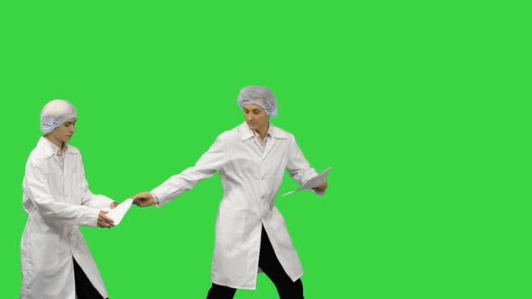 Three Male Doctors in White Robes and Protective Caps Passing on Document While Dancing in a Row on alt