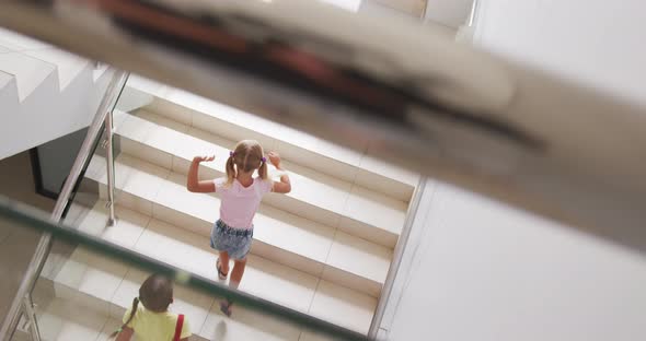 Video of top view of diverse girls walking upstairs at school alt