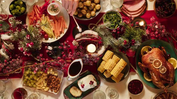 Hand Lighting Candles on Dining Table Top View alt