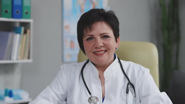 Confident Woman Wear White Medical Coat with Stethoscope Looking at Camera