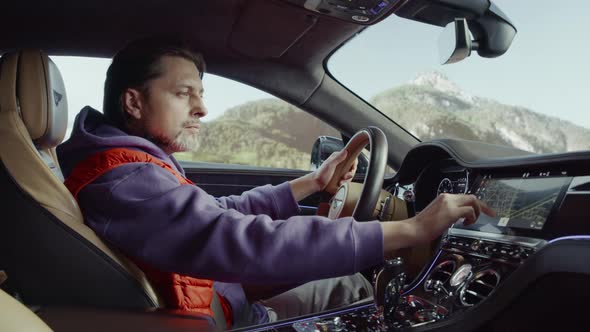 The driver driving the car looks at the road on the map.