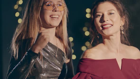 Close Up Couple of Young Multiracial Girls Wearing Plush Dresses Enjoying Glamorous Party and Having alt