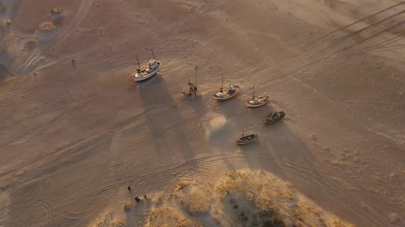 Aerial Shot of Four Boats and Shadows on the White Sands By the Beach alt