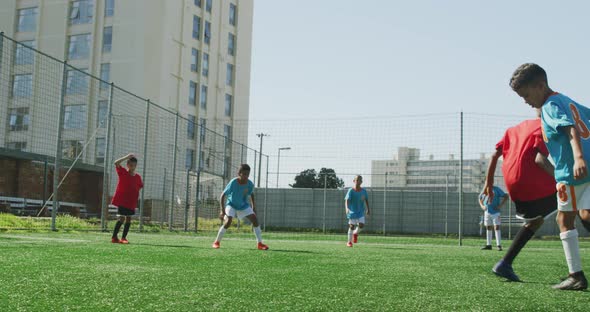 Soccer kids playing in a sunny day alt