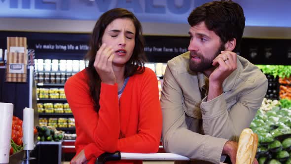 Couple ignoring each other in organic section alt