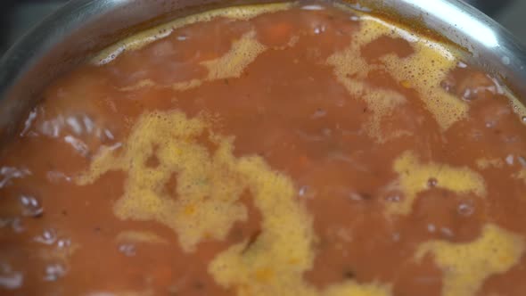 Saucepan with a homemade tasty borsch. Red beetroot vegetable soup, close up alt