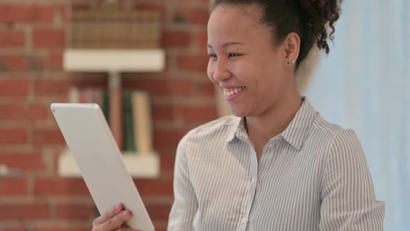 Portrait of African American Woman Doing Video Call on Tablet alt