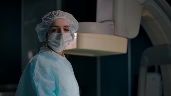 Portrait of a Young Female Surgeon Taking Off Her Mask After a Successful Operation alt