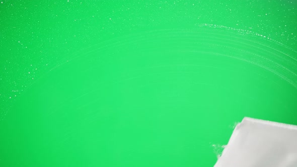 Cleaning Glass Using Spray Detergent on Green Chroma Key Background alt