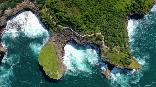 Secluded path on cliffs, Kesirat beach diverse shoreline, Indonesia, aerial view alt