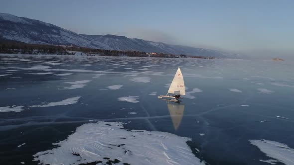 Sailing Ships Yacht Skates on Ice Skate. Ice-boat Sailing on Lake Baikal