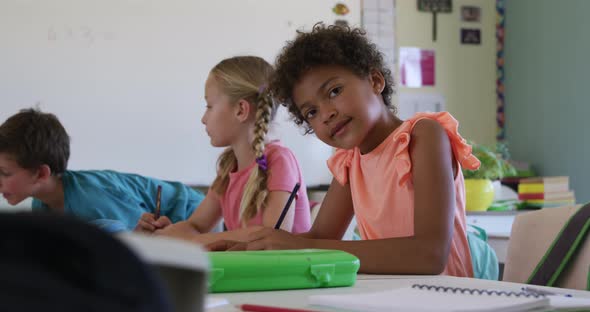 Girl smiling while studying in the class alt