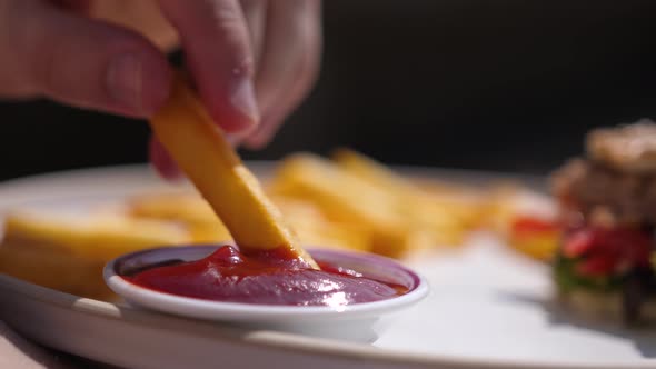 French Fries Is Dipping in Red Tomato Sauce