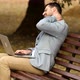 Pain in neck. Man in park, he experiences severe pain in neck. Work on laptop. - VideoHive Item for Sale